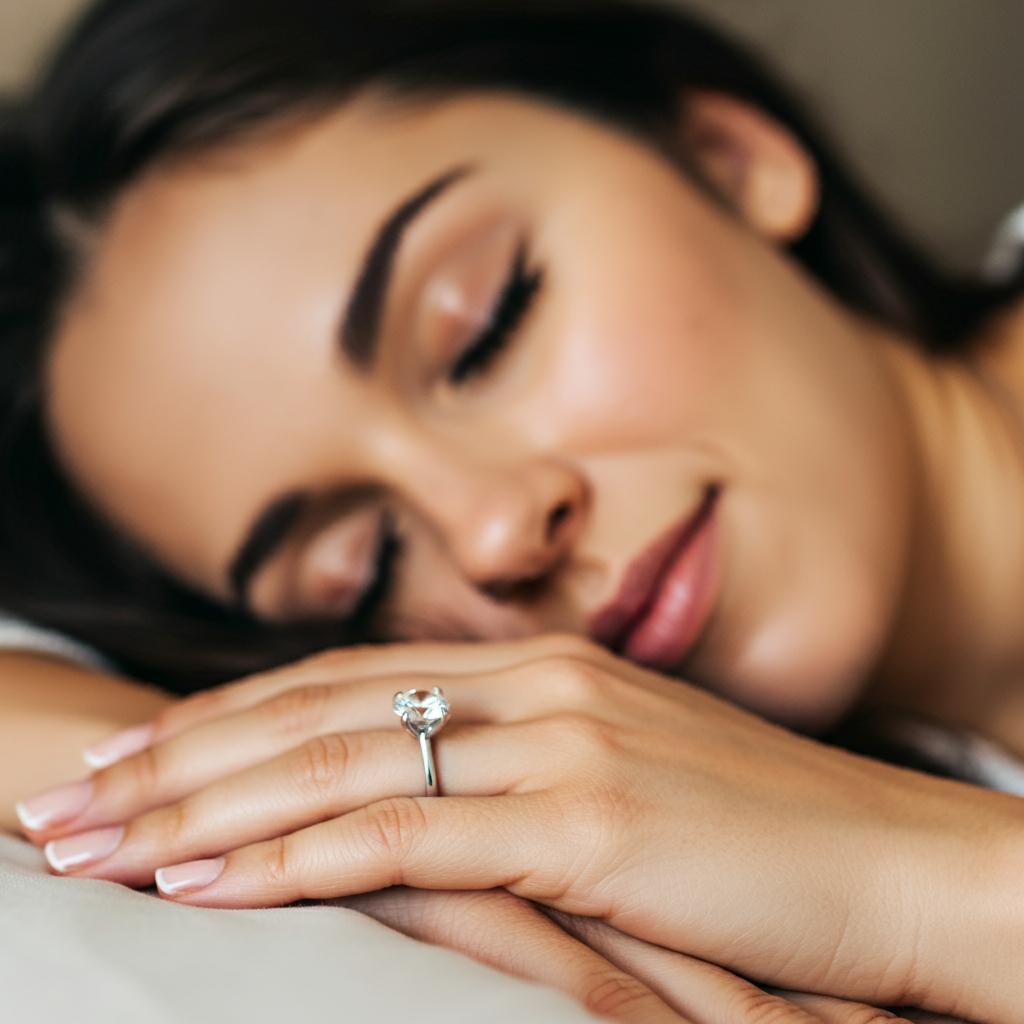 A person contemplating whether to sleep with their ring on, surrounded by bed linens.