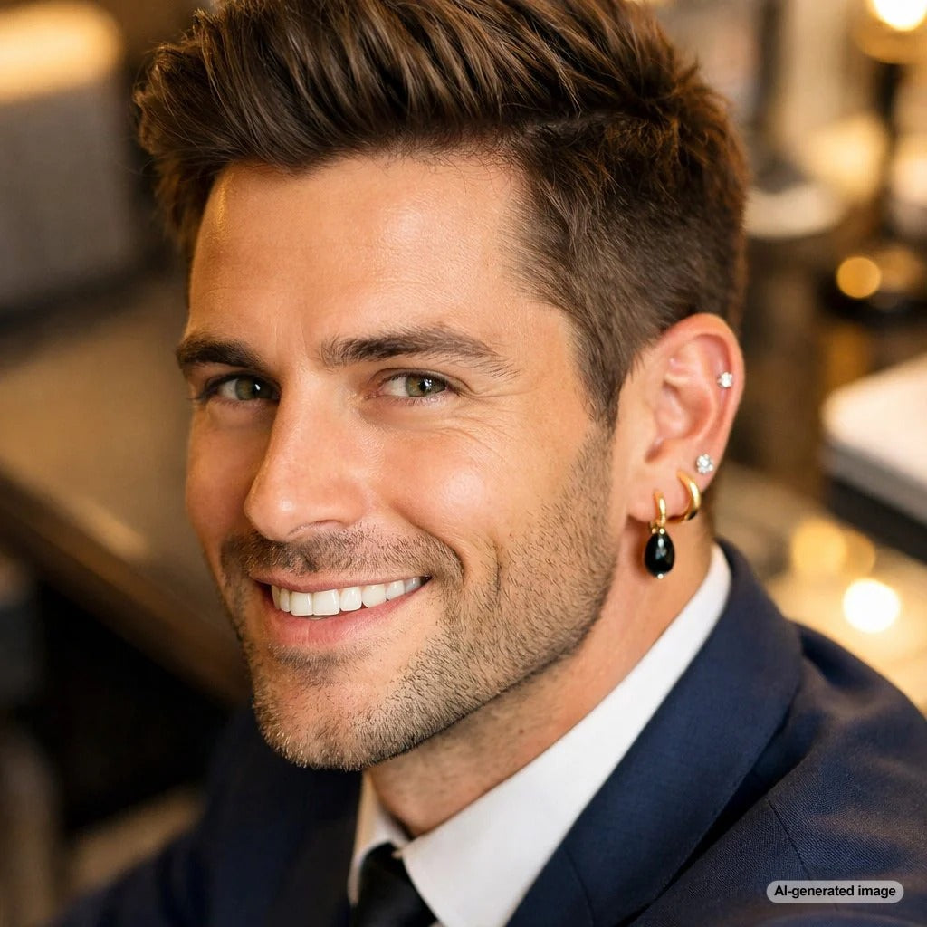 A stylish man wearing a gold hoop earring and a diamond stud earring, showcasing versatile men's earring styles from Robinson's Jewelers.