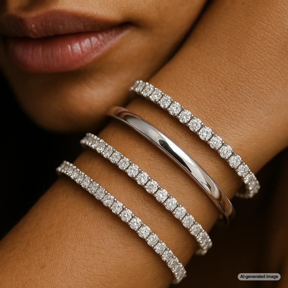 Elegant white gold jewelry including rings, bracelets, and necklaces displayed on a velvet tray