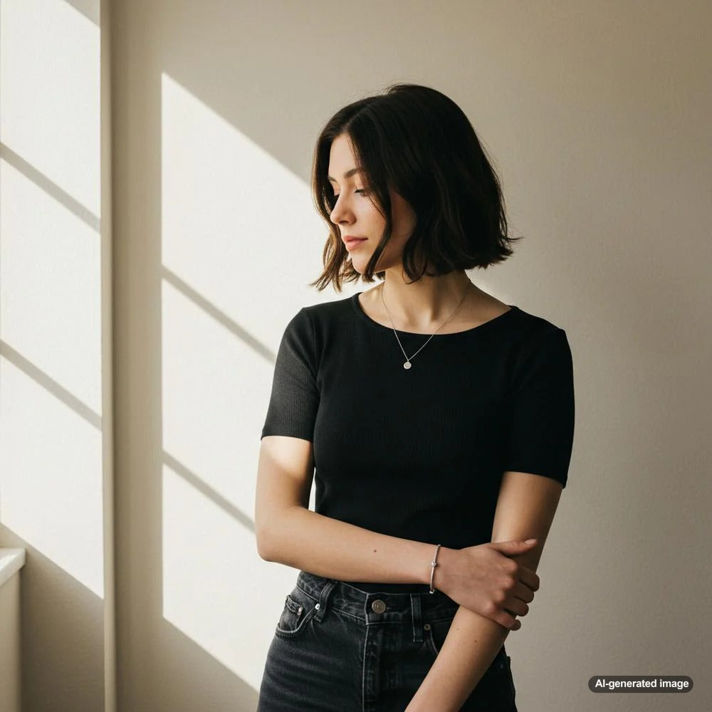 Minimalist Jewelry: Delicate Gold Necklace and Rings on a White Background