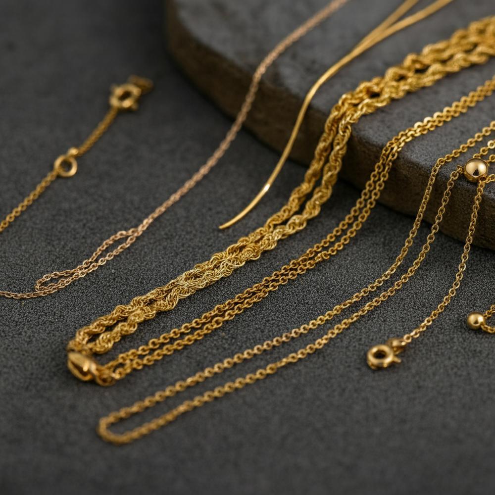 Close-up of 14 karat yellow gold jewelry pieces showcasing varying hues and finishes