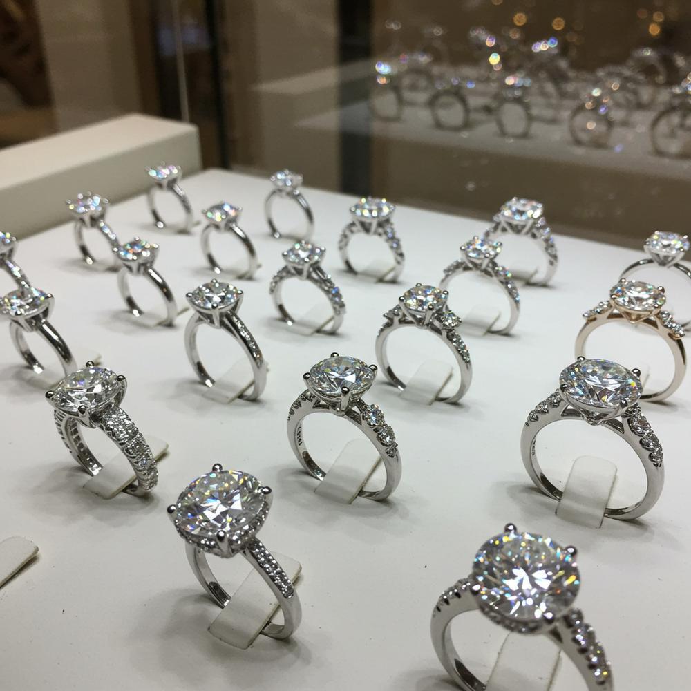 Lab grown diamond engagement ring with halo setting on velvet background