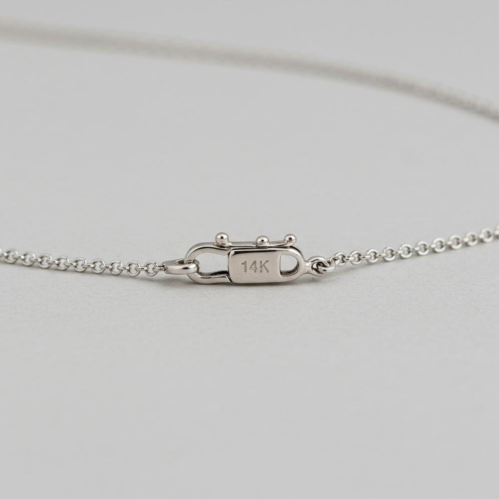 Close-up of a white gold ring showing the 14K stamp inside the band