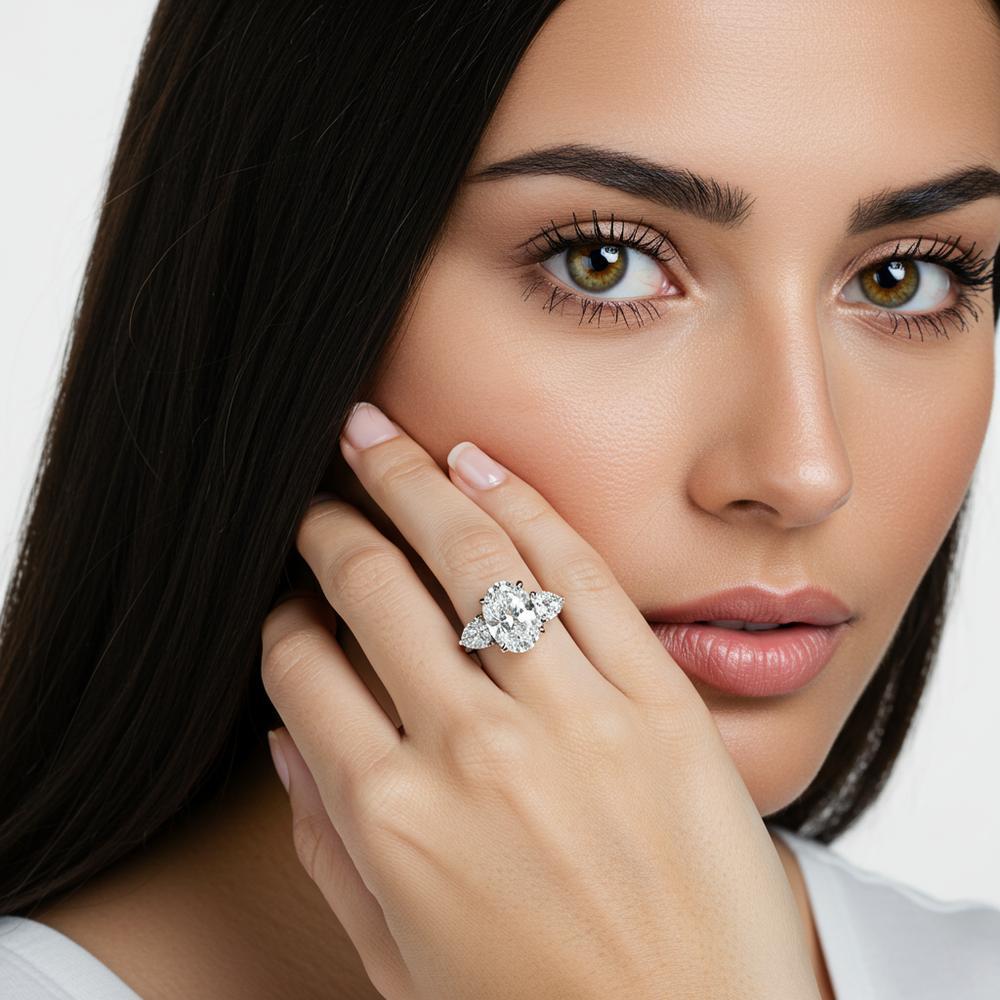 A stunning three-stone diamond engagement ring showcasing the perfect ratio between center and side stones