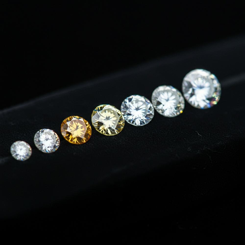 A spectrum of colored diamonds showcasing various hues from colorless to vibrant shades.