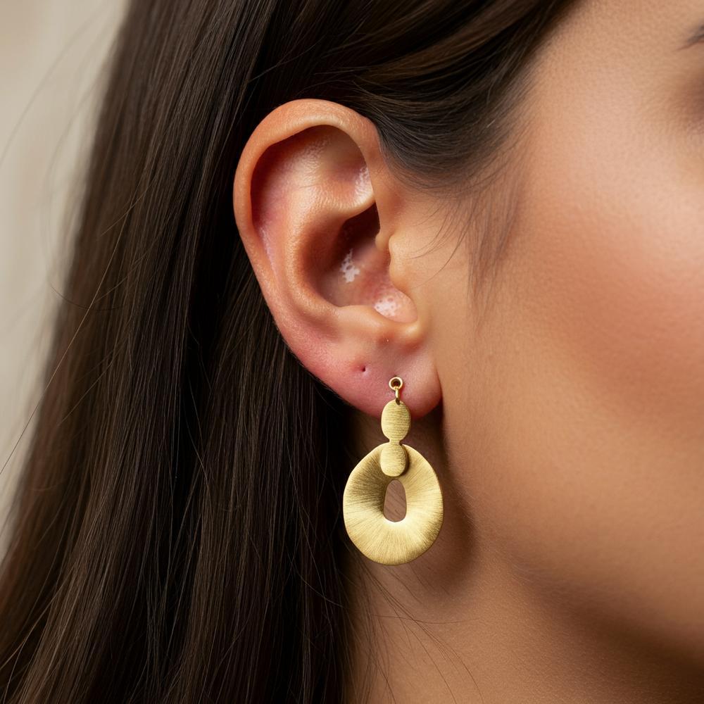 Close-up of an ear with multiple earrings showcasing different styles