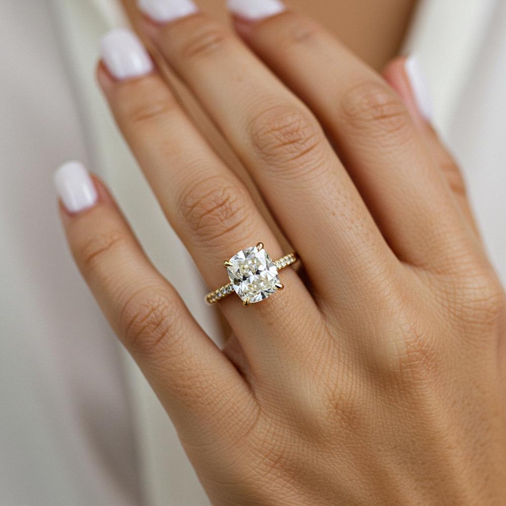 Close-up of a sparkling diamond engagement ring being sized on a ring sizer tool