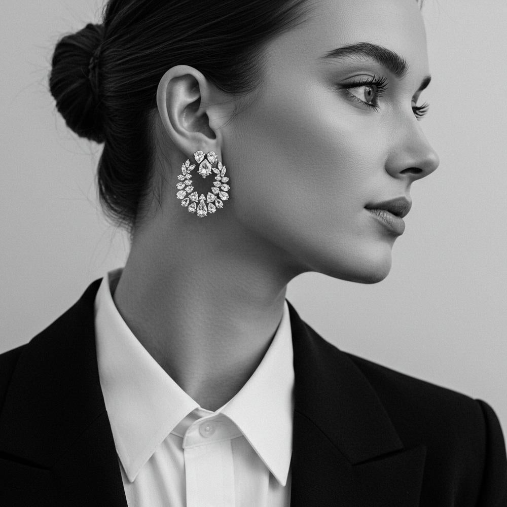 A stylish woman wearing bold statement earrings with a minimalist outfit.