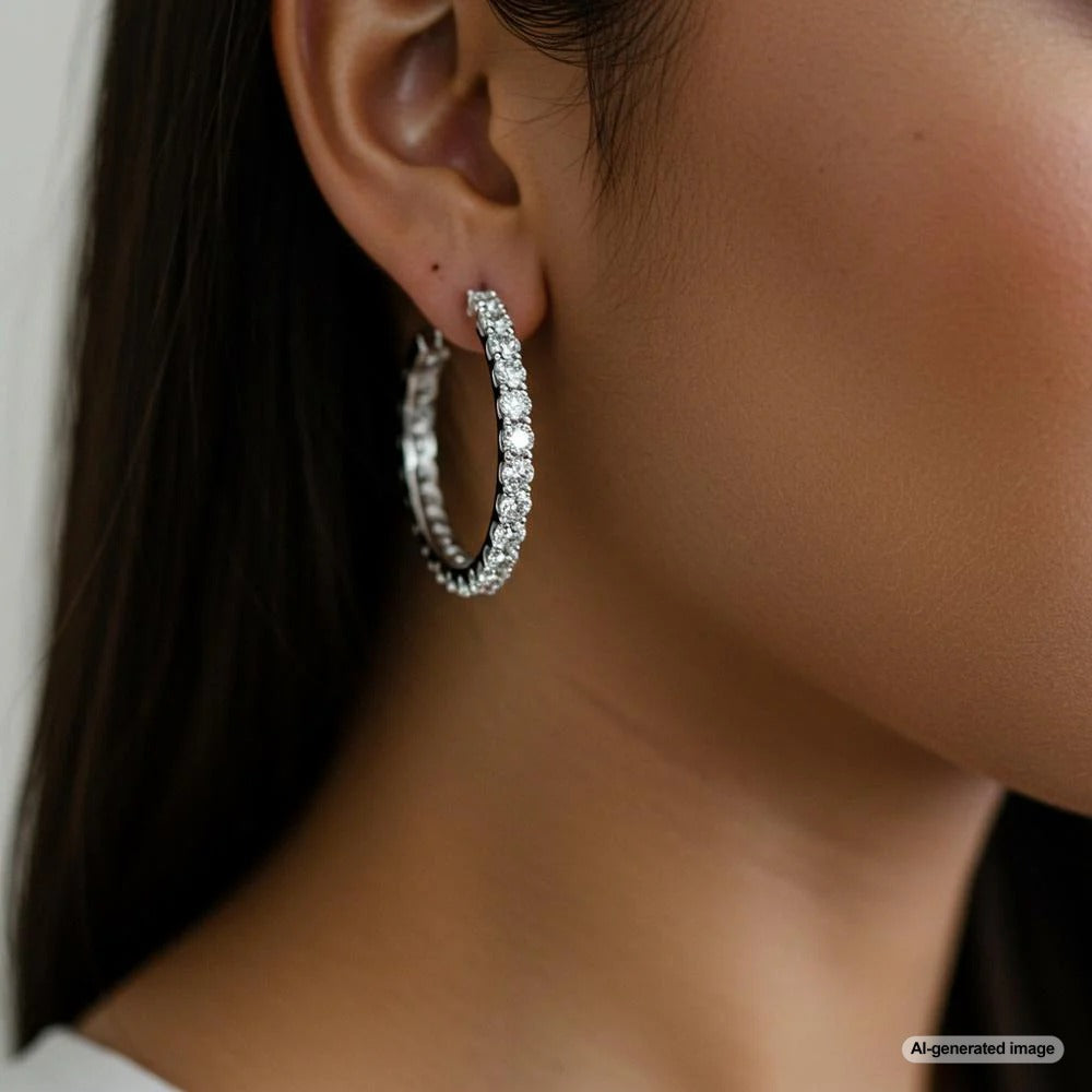 Woman wearing stylish gold hoop earrings with an elegant outfit.
