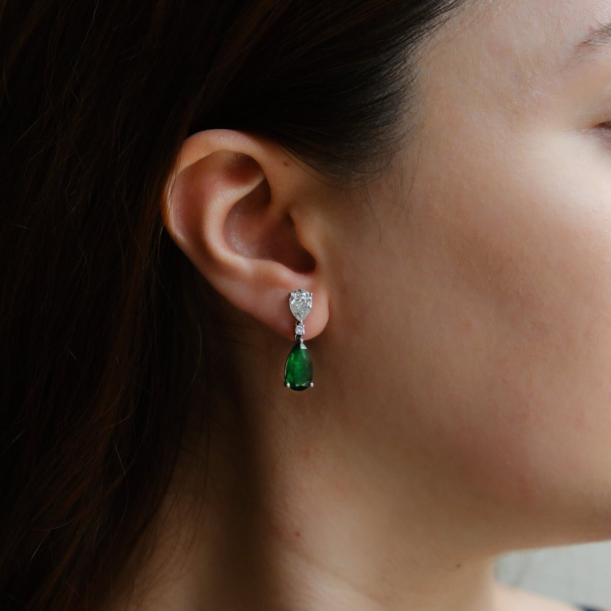 Stunning Belcanto diamond earrings with emerald accents in white gold by Ruchi New York