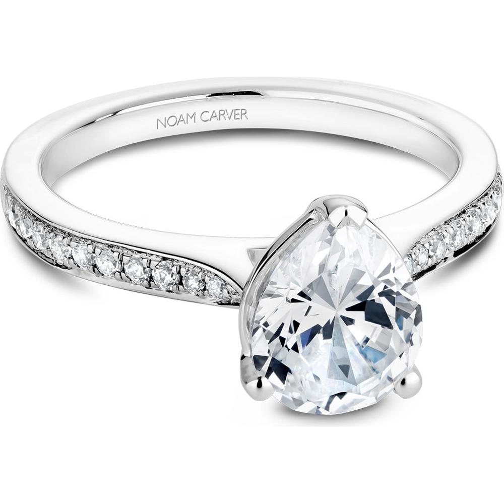 Pear-shaped diamond engagement ring with three-prong setting and pave band in white gold by Noam Carver