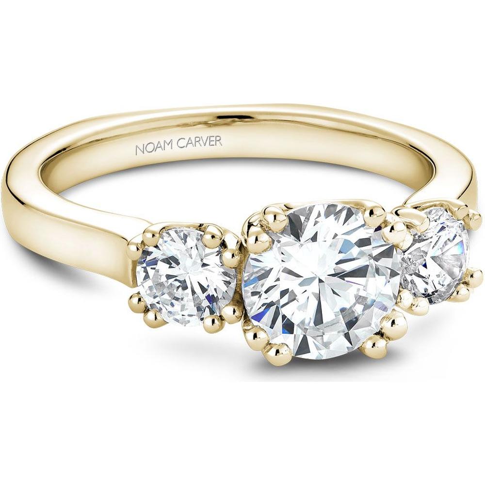 A round-cut diamond ring featuring classic prong settings in yellow gold.