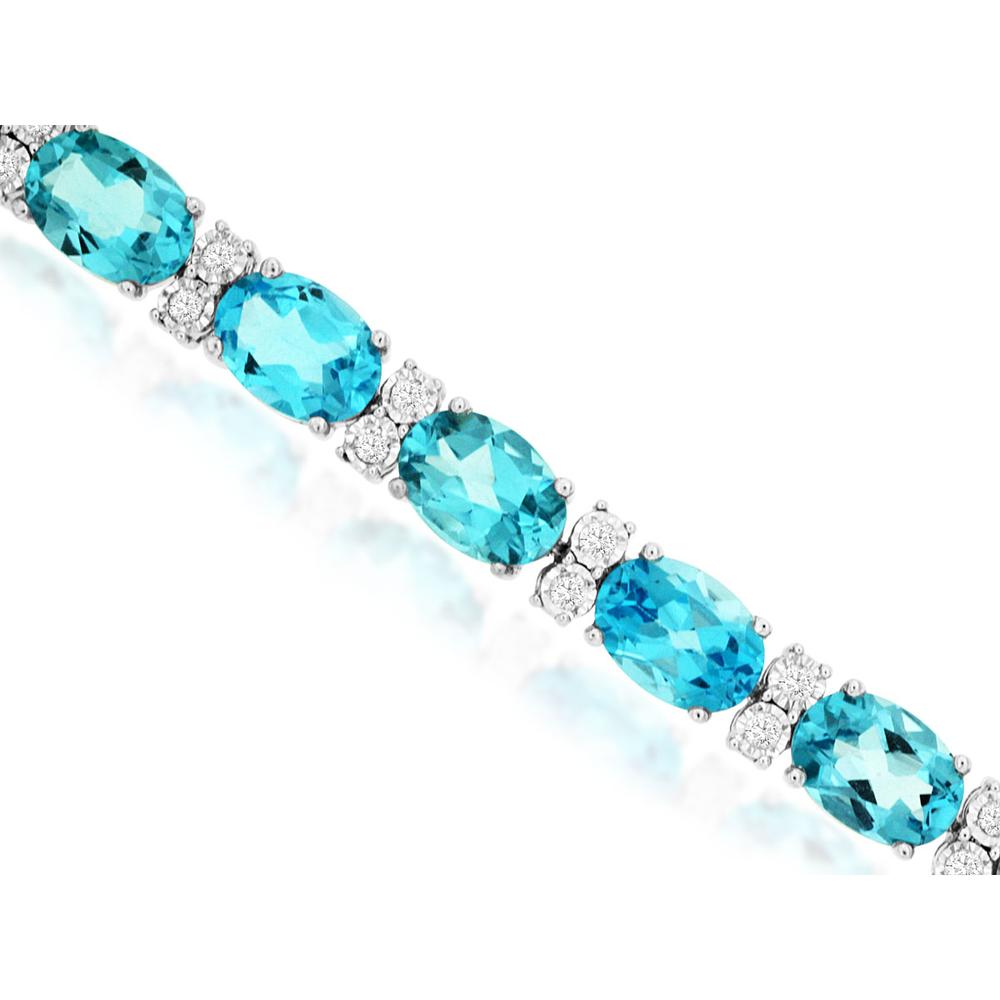 A stunning 14K white gold tennis bracelet featuring oval blue topaz and diamonds, reflecting the elegance of November birthstones.