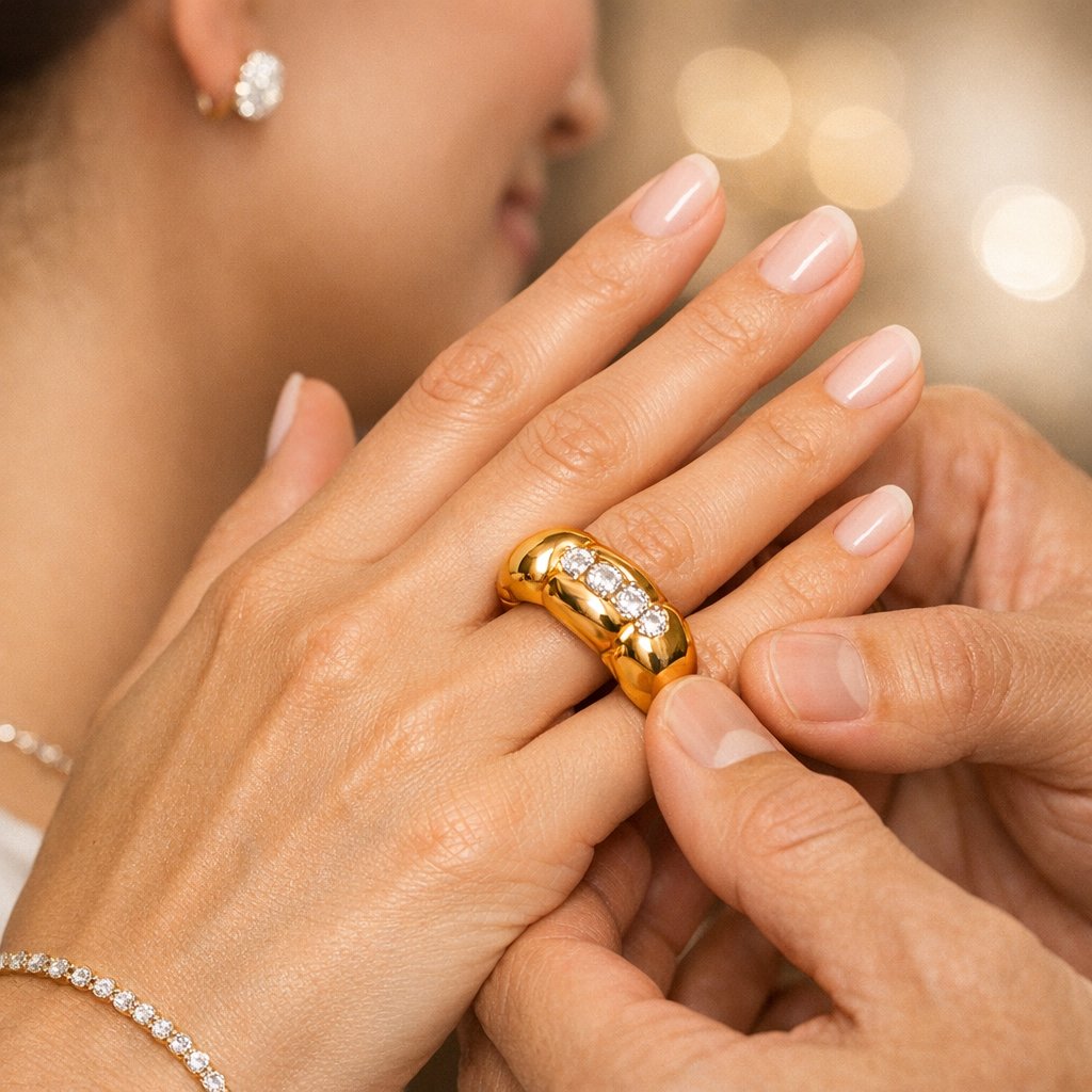 A woman models a chunky, lightweight inflated gold necklace from the Helium Collection, showcasing bold and airy luxury jewelry.