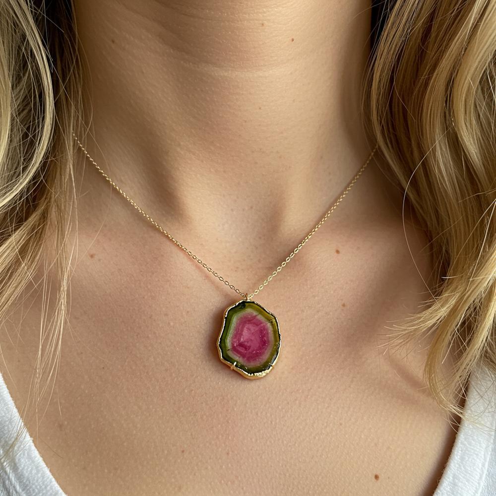 A stunning Watermelon Tourmaline gemstone showcasing its vibrant pink center and green outer layer, set in an elegant jewelry piece.