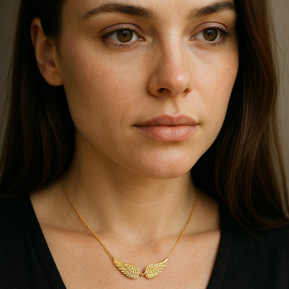 Elegant angel wing necklace in sterling silver resting on a satin cloth