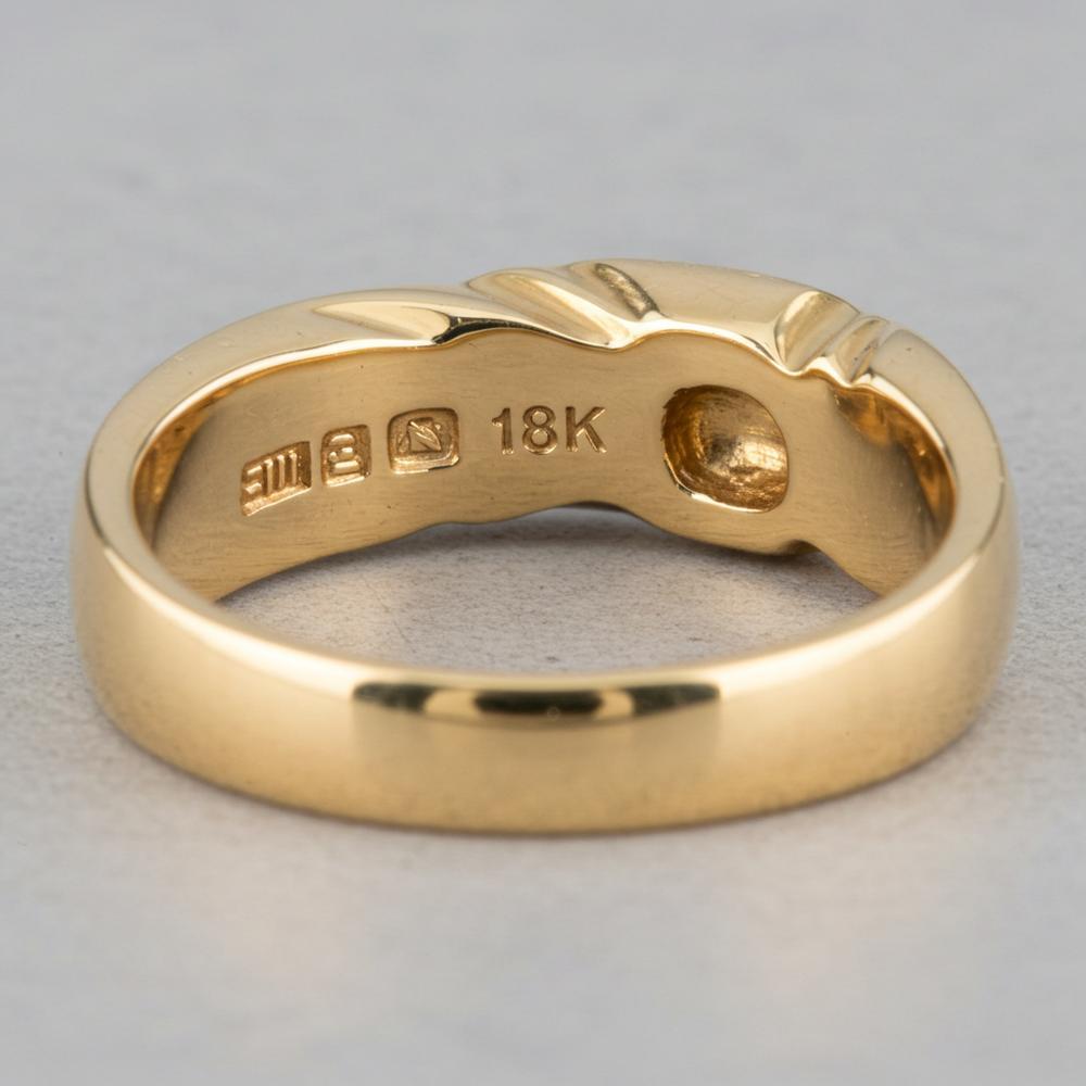 Gold jewelry stamped with 750, indicating 18K gold purity
