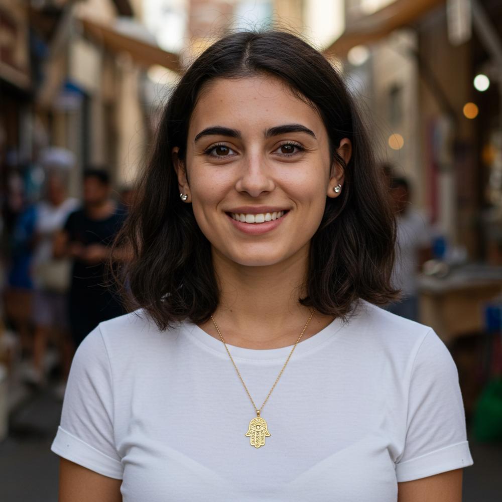 Hamsa Hand charm jewelry in gold with intricate detailing, symbolizing protection and blessings