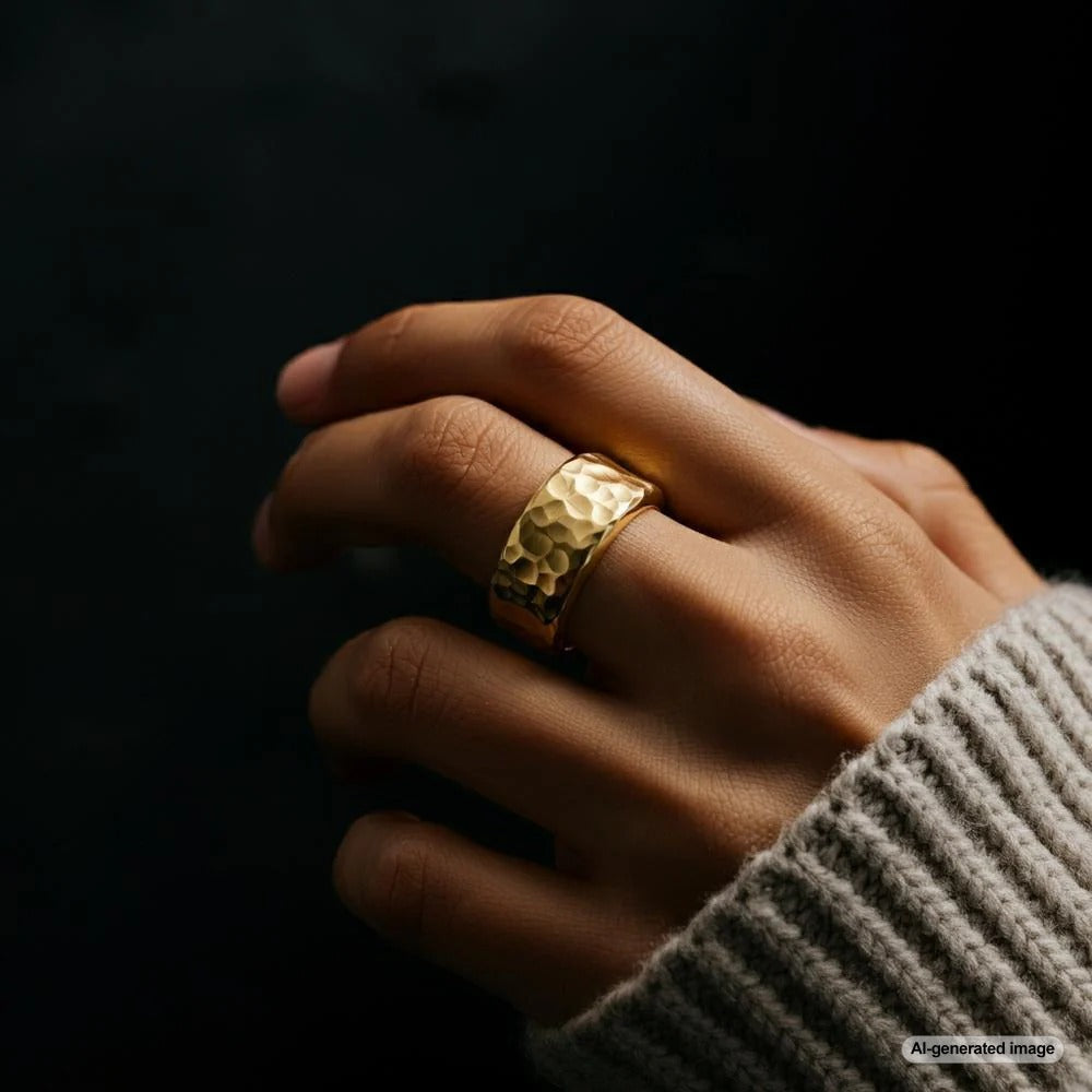 Hand adorned with a ring on the middle finger, symbolizing balance and responsibility