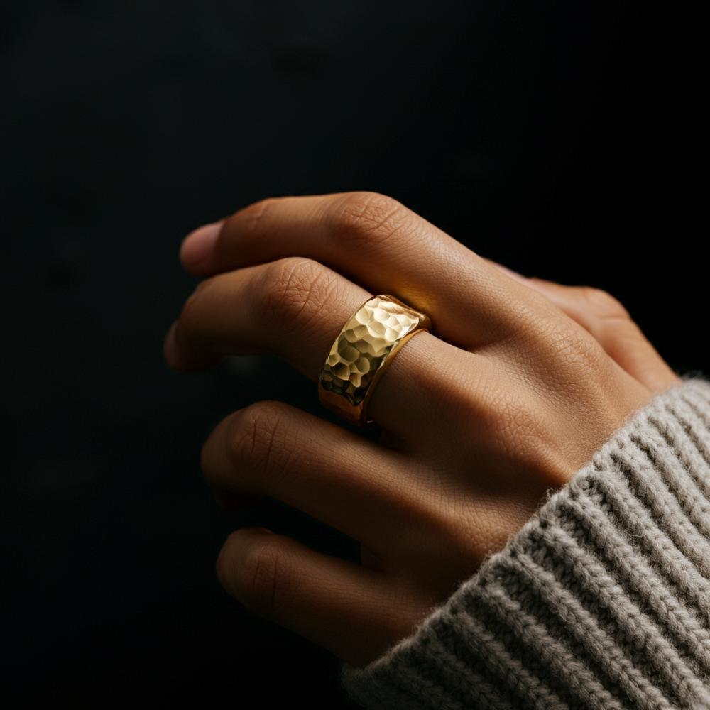 Hand adorned with a ring on the middle finger, symbolizing balance and responsibility