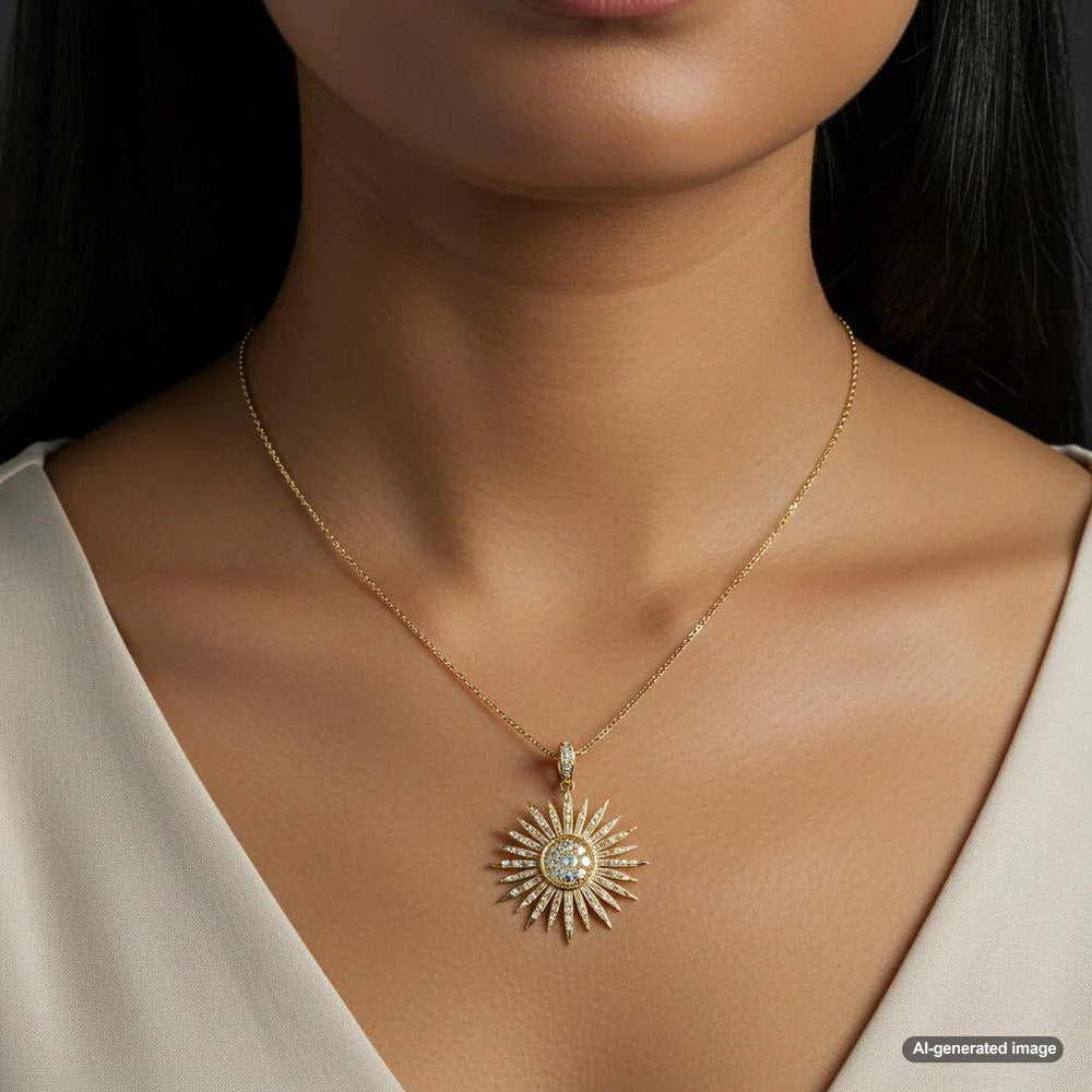 Sunburst pendant necklace in yellow gold with diamond accents, symbolizing energy and renewal.