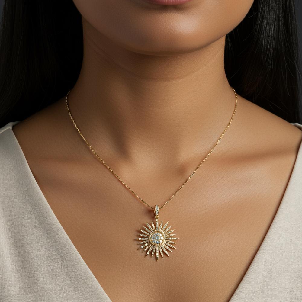 Sunburst pendant necklace in yellow gold with diamond accents, symbolizing energy and renewal.