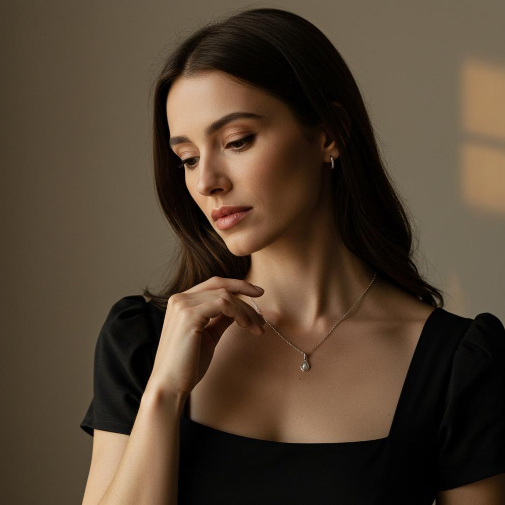 A woman touching her elegant necklace, showcasing delicate jewelry and thoughtful expression.