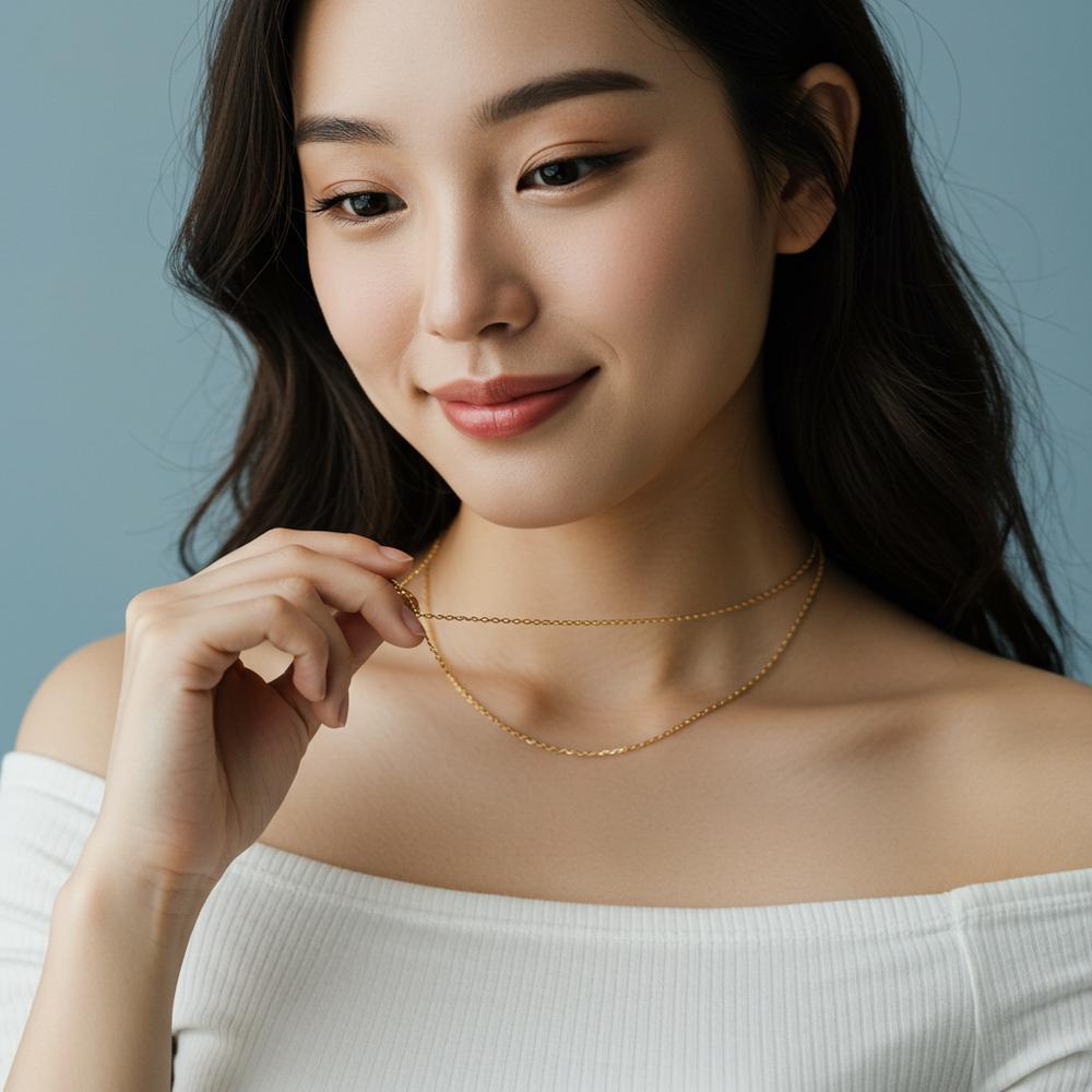 A close-up of a woman gently holding and fiddling with a delicate gold necklace, showcasing the emotional connection people have with their jewelry.
