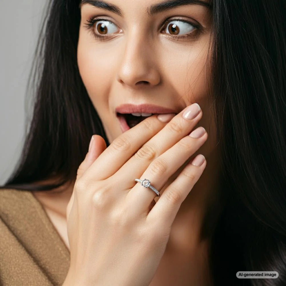 Close-up of a ring missing its central gemstone