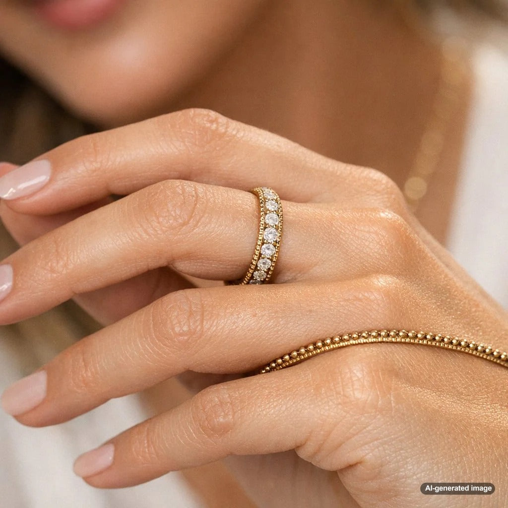 Close up detail of a yellow gold ring featuring a beaded edge milgrain texture on the band.