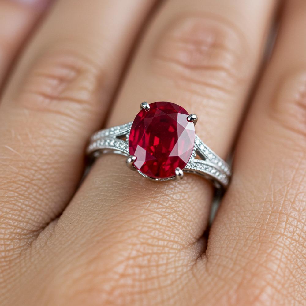 A stunning oval-cut ruby set in a elegant gold ring, showcasing its deep red color and brilliance.