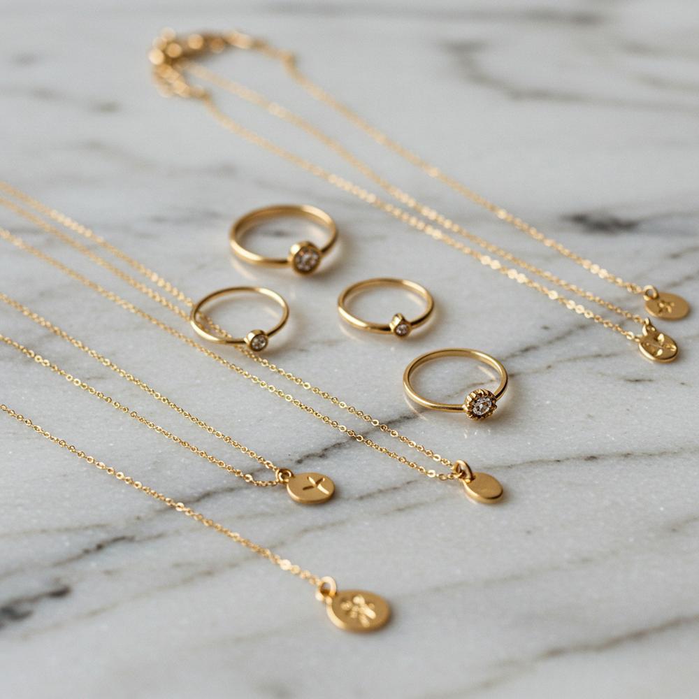 Comparison of 14k and 18k gold jewelry showcasing rings, necklaces, and bracelets