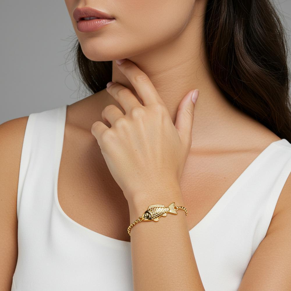 Elegant gold fish pendant necklace with sparkling diamonds on display at Robinson's Jewelers