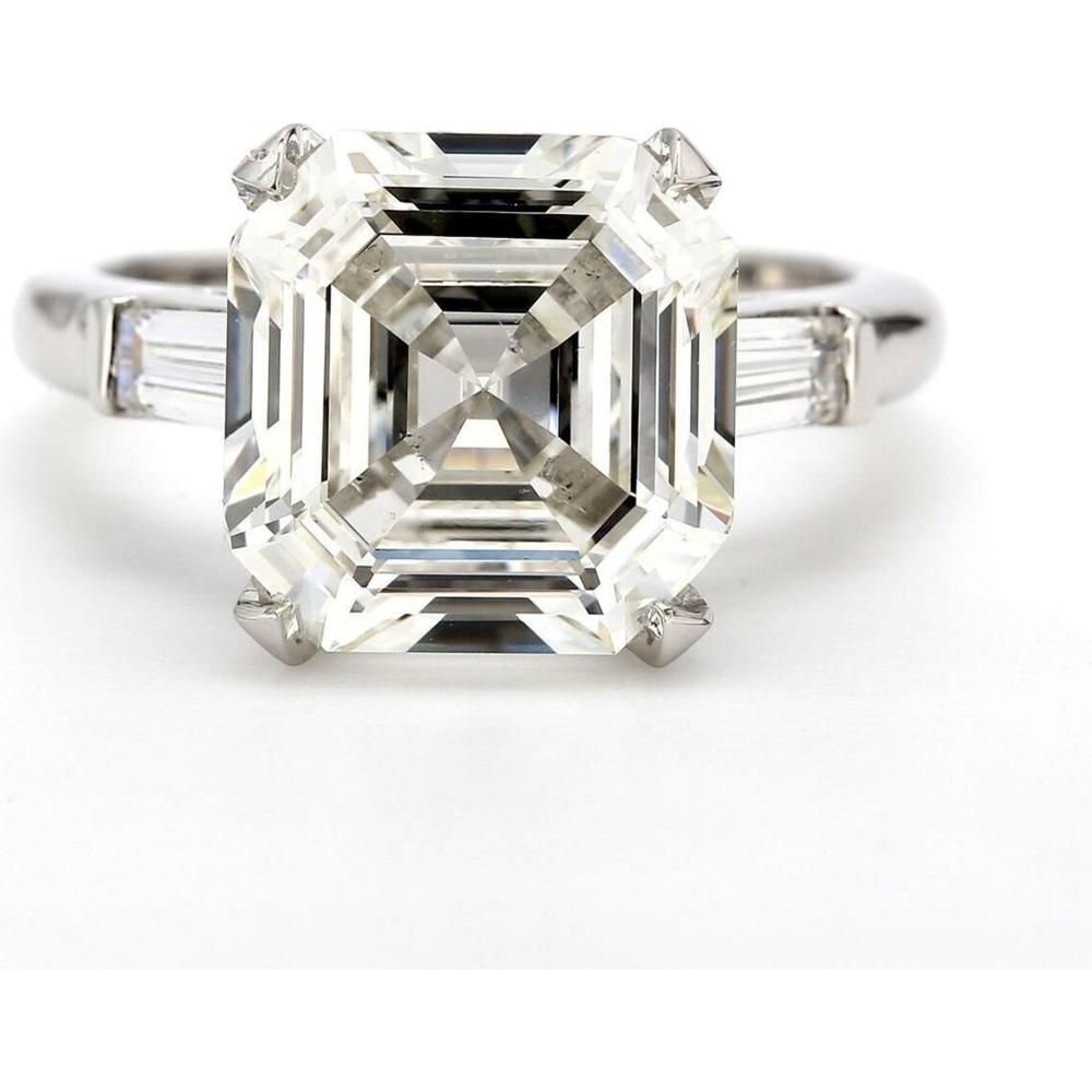 Elegant three-stone diamond engagement ring showcasing brilliant cut stones in a classic setting