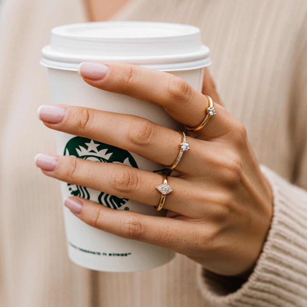 Elegant arrangement of three beautiful rings - a diamond band, gemstone ring, and gold signet ring stylishly stacked together