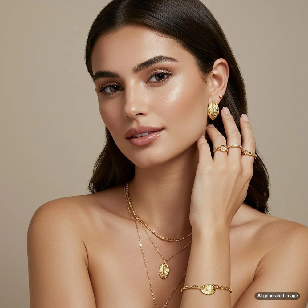 A stunning brunette model showcasing gold jewelry, highlighting the perfect match of warm gold tones with dark hair.