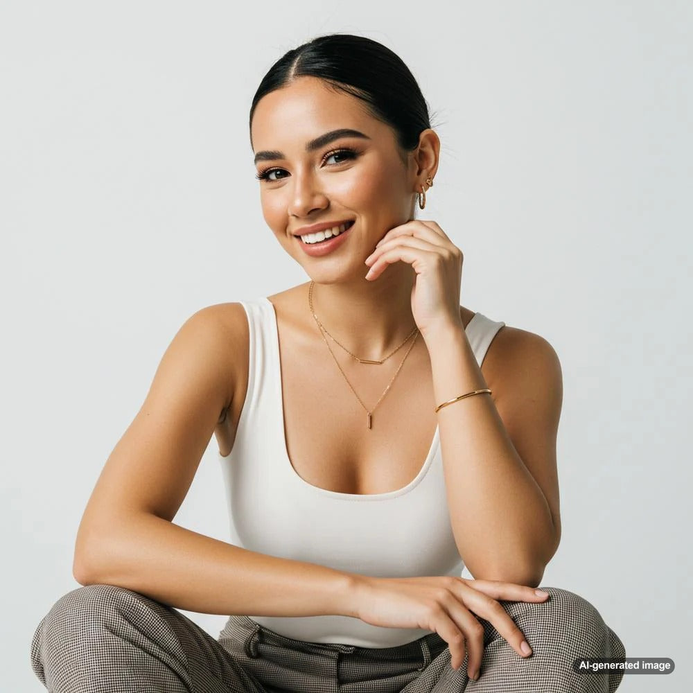 Minimalist jewelry featuring diamond studs, a solitaire pendant, and hoop earrings