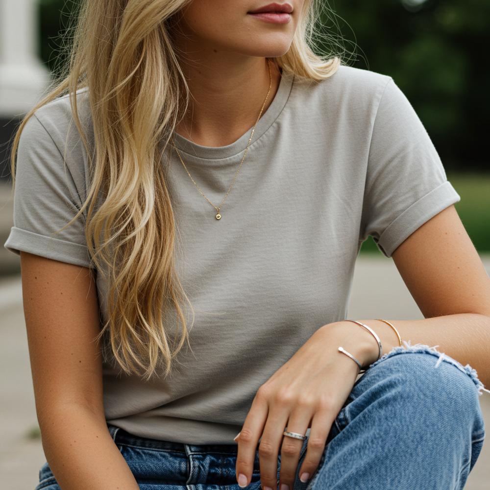 A collection of minimalist jewelry pieces including delicate rings, simple necklaces, and elegant bracelets, perfect for a casual day.