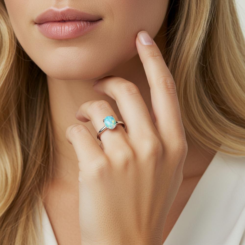 An elegant opal engagement ring displaying a mesmerizing play-of-color, set in a delicate gold band.