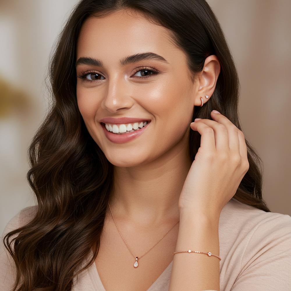 A stunning collection of rose gold jewelry featuring rings, necklaces, and bracelets.