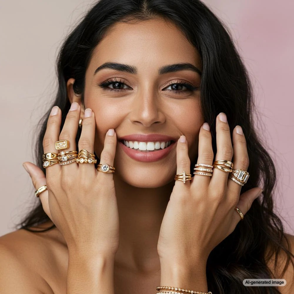 A stunning collection of stackable rings in gold, silver, and rose gold with diamonds and gemstones, beautifully arranged on a velvet tray.