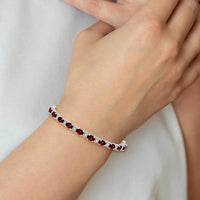 14K White Gold 7" Oval Garnet and Round Diamond Tennis Bracelet - 0.60 Carats Garnet, 0.005 Carats Diamond by Monteluci Fine Jewelry