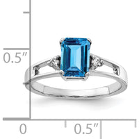 14K White Gold 7x5mm Emerald Cut Swiss Blue Topaz Ring with Diamond Accents - 1.3 Carat Total Blue Topaz Weight, 0.02 Carat Diamond Weight by Monteluci Fine Jewelry