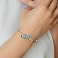 14K White Gold Blue Topaz and Diamond Heart Flexible Bangle Bracelet - 2.16 Carats Blue Topaz, 0.12 Carats Diamonds by Monteluci Fine Jewelry