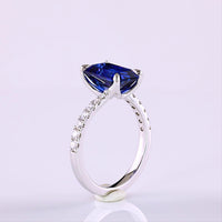 14K White Gold Bypass Ring with 3.59 Carat Emerald Cut Blue Lab Sapphire and 0.24 Carat Round Lab Diamond Accents - Total 3.88 Carats - Covaloro Fine Jewelry