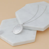 14K White Gold Floral Border Oval Locket with Engravable Back - 32mm x 24.5mm by Monteluci Fine Jewelry