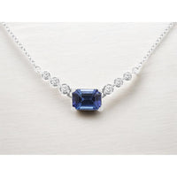 14K White Gold Geometric Bar Necklace with Bezel-Set Round Diamonds and 4-Prong Step-Cut Tanzanite Center - 1.15 Carat Tanzanite and 0.14 Carat Total Diamond Weight - Royal Jewelry