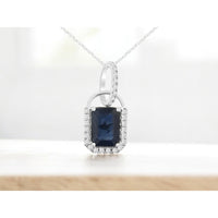 14K White Gold Halo Pendant Necklace with Emerald Cut Sapphire and Round Diamond Accents - 1.08 Carat Sapphire and 0.10 Carat Total Diamond Weight - Royal Jewelry