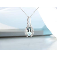 14K White Gold Halo Pendant with Oval Aquamarine and Pavé Diamond Accents - 0.68 Carat Aquamarine and 0.10 Carat Total Diamond Weight - Royal Jewelry