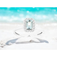 14K White Gold Halo Ring with Emerald-Cut Aquamarine and Round Diamonds - 0.45 Carat Aquamarine and 0.15 Carat Diamond Total Weight - Royal Jewelry
